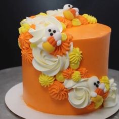 an orange and white cake decorated with flowers