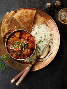 a plate with rice, meatballs and pita bread