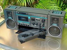 an old stereo system sitting on top of a table