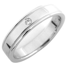 a white gold wedding ring with a diamond