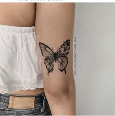 a woman's arm with a butterfly tattoo on the left side of her body