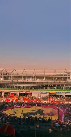 a stadium full of people watching a baseball game from the bleachers at sunset