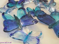 blue glass butterflies sitting on top of a white table