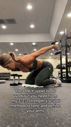 a woman doing squats on the floor in a gym with an exercise poster above her