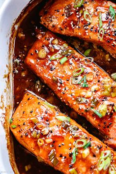 baked salmon with sesame seeds and seasoning in a white dish