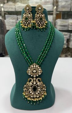 Victorian Style Peacock Design Green Beaded Long Necklace Kundan CZ Diamond Jewelry Pearl Silver Foil Sabyasachi Inspire Indian Wedding Set  Color :  Green And Gold  Gemstone :  Cubic Zircon / Green Quartz / Pearl / CZ Diamond  Product Type :   Necklace Earring Set,  Product Details : Necklace Length : Approx. :  10 Inches  Earring Length     : Approx. :  2 Inches  Made of Long Lasting Brass Metal, Good Quality. Hand Finished. Raw material - Artificial Jewelry,  CZ Diamond,  White Pearl  Occasion:  Will add luster when worn for a wedding, engagement, party, prom and any special occasion. Will enhance special days like                       Valentine's day, Birthdays, Anniversaries, and Mother's Day. These stylish Jewelry from will certainly leave you spellbound. These Jewelry have an excel Panda Jewelry, Artificial Jewelry, Emerald Green Earrings, Victorian Necklace, Emerald Bead, Peacock Design, Jewelry Pearl, Fashion Jewelry Sets, Necklace Green