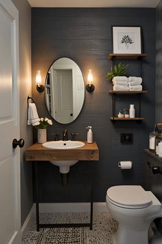 a white toilet sitting next to a sink in a bathroom under a large round mirror