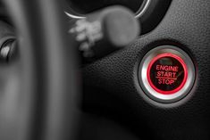 an engine start button on the dashboard of a car