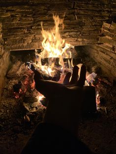 a person is sitting in front of a fire