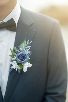 a man in a tuxedo with a boutonniere on his lapel