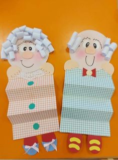 two paper dolls made to look like they are standing next to each other