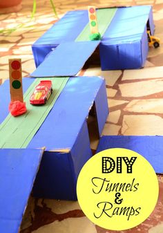 two children's wooden toy cars are on the ground