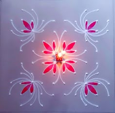 a candle that is lit up in the middle of a flower design