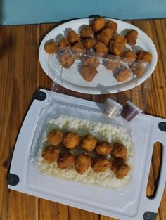 two plates filled with food on top of a wooden table