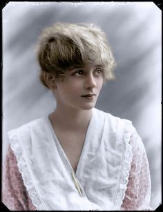 an old photo of a woman with short hair