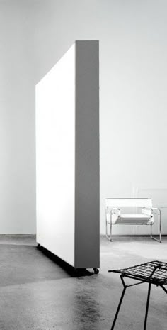 a tall white cabinet sitting in the middle of a room