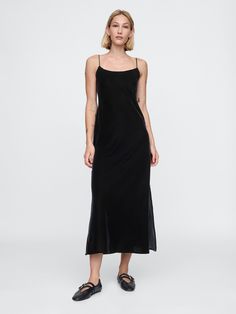 Soft, smooth velvet maxi slip dress.  Scoop neck.  Adjustable spaghetti straps.  Slit at hem.  This dress is made with 100% recycled polyester.  Compared to virgin materials, using recycled materials helps to reduce resource use and waste.  Fit: Slim.  An A-line silhouette that sits close to the body with a flared opening.  Models wearing Gap Black Tea Dress, Black Velvet Maxi Dress, Sleeveless Velvet Dress, Rush Outfits, Slip Dress Black, Velvet Maxi Dress, Velvet Maxi, Shoe Inspo, Maxi Slip Dress