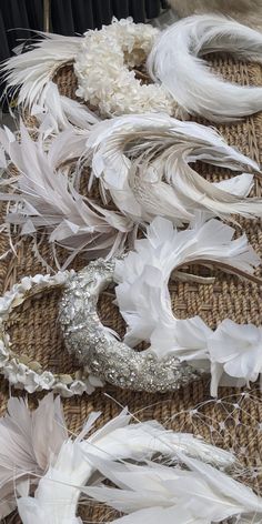 several white feathers are laid out on the floor and ready to be used as decorations