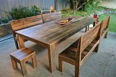 a wooden table with benches around it