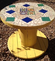 a yellow table with blue and green tiles on it