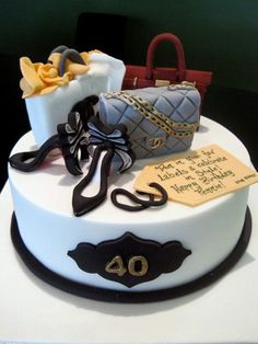 a white cake with purses and handbags on it