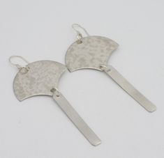 Long, elegant earrings cut from leadfree pewter sheet.  Textured with hammer;  linear bar is brush-finished.  Earrings have a bit of Asian flair to themthe top section is shaped like a fan. Reminds me of the lovely fans used by geishas! Earrings are about 3 1/2 inches in length, inc handmade sterling silver french wires. Back of earring is signed SW Japanese Earrings, Hammered Silver Brass Earrings, Hammered Sterling Silver Linear Earrings, Modern Sterling Silver Hammered Linear Earrings, Sterling Silver Modernist Earrings, Modernist Sterling Silver Pierced Earrings, Japanese Fan, Ginkgo Leaf, French Wire