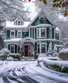 a large green house with wreaths on it's windows and snow covered ground