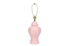 a pink lamp is hanging on a white wall