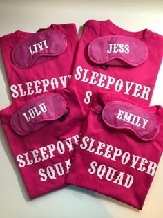 four pink sleepovers with white writing on them are laying next to each other and one is wearing a sleeping mask