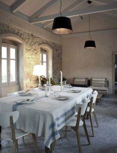 a dining room table is set with place settings for six people, and the lights are turned on