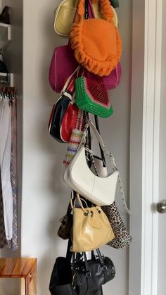 a bunch of purses are hanging on the wall