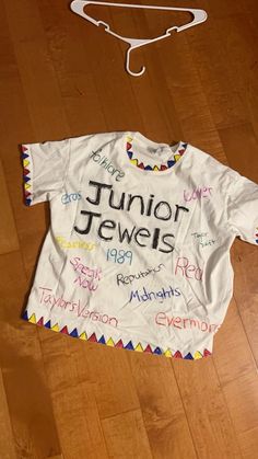 a t - shirt with the name junior jewels written on it and a hanger