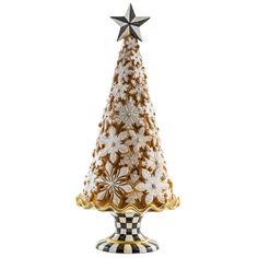 a glass christmas tree with white and gold flowers on it's base, sitting on a checkerboard pedestal