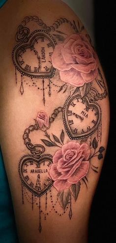 a woman's arm with roses and an old clock tattoo on the back of her shoulder