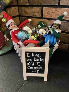 an elf's christmas basket with ornaments in it and a sign that says i like big balls and i cannot't lie