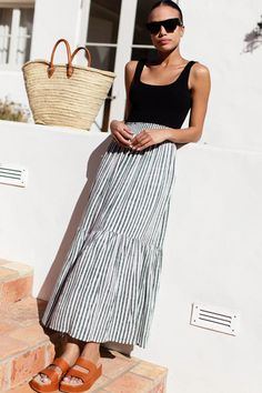 - Modal (a natural, sustainable fabric) - Easy pull on styling - Elastic shirred waist band - Tiered skirt - Maxi Length - Unlined - Model is 5'9” - Hand wash, line dry - Made in Rajasthan, India Striped Maxi Skirt Outfit, Midi Skirts Style, Shirred Skirt, Travel Looks, Minimal Wardrobe, Summer Outfits 2024, Maxi Skirt Outfits, Striped Maxi Skirts, Striped Midi Skirt