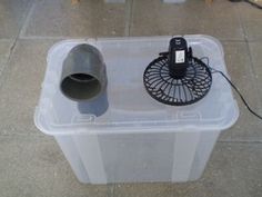 a plastic box with a fan on top of it that says, i've been searching ways to keep cool in the heat while camping