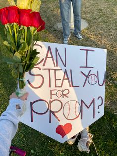 a sign that says can i steal you for prom? with flowers in front of it