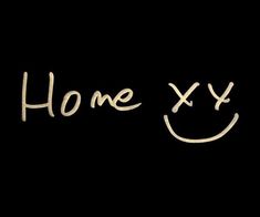 the words home x and y are written in white chalk on a black background with a smiley face