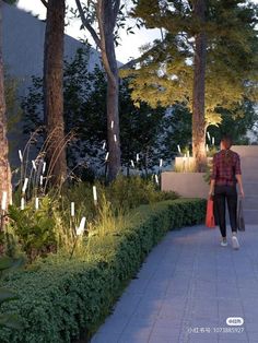 a man is walking down the sidewalk with his bag in hand and trees behind him