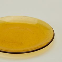 a yellow plate sitting on top of a white table