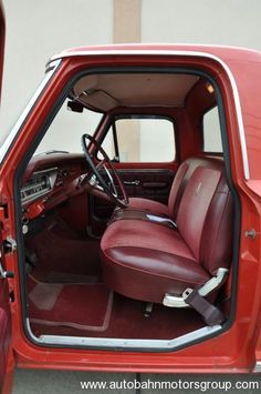 the interior of a red truck with its door open