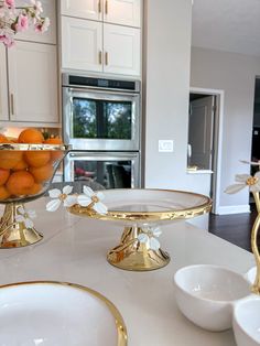 two plates with oranges in them sitting on a kitchen counter