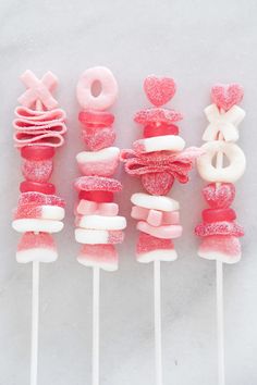 pink and white lollipops are arranged on top of each other in the shape of hearts