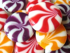 many different colored lollipops are stacked on top of each other