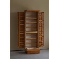 a tall wooden cabinet with shelves in it