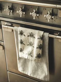 a kitchen towel hanging on an oven door knobs and burners in the background