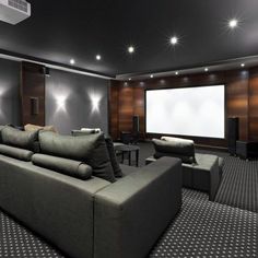 a large living room filled with furniture and a flat screen tv mounted to the wall