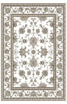 a white rug with an ornate design on the bottom and green trimmings around it