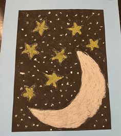 a drawing of a crescent moon and stars on a black paper with gold glitters